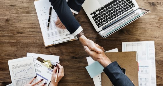 Business people shaking hands together